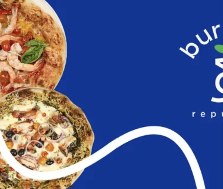 Two wood-fired pizzas on a blue background