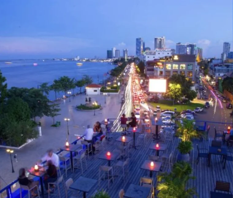 Rooftop terrace at dusk overlooking the Phnom Penh riverside